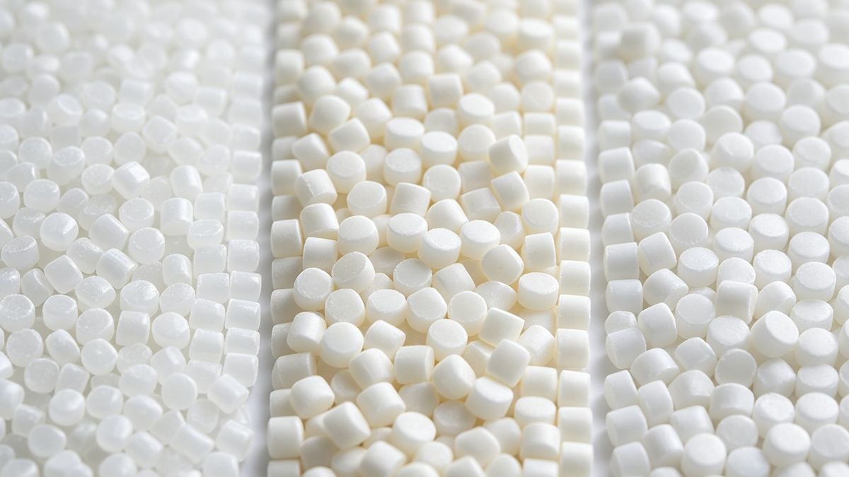 Plastic resin pellets showing different material types for injection molding.