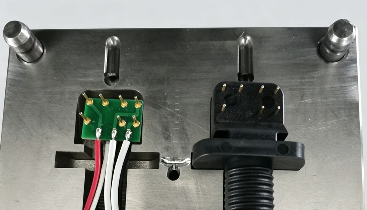Finished electronic component protected by low pressure molding encapsulation.