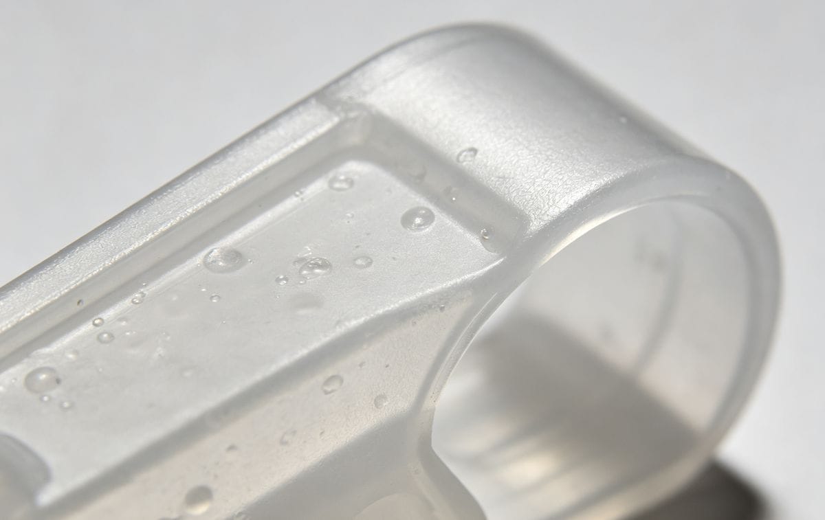 Close-up of vacuum voids and gas bubbles in an injection molded plastic part.